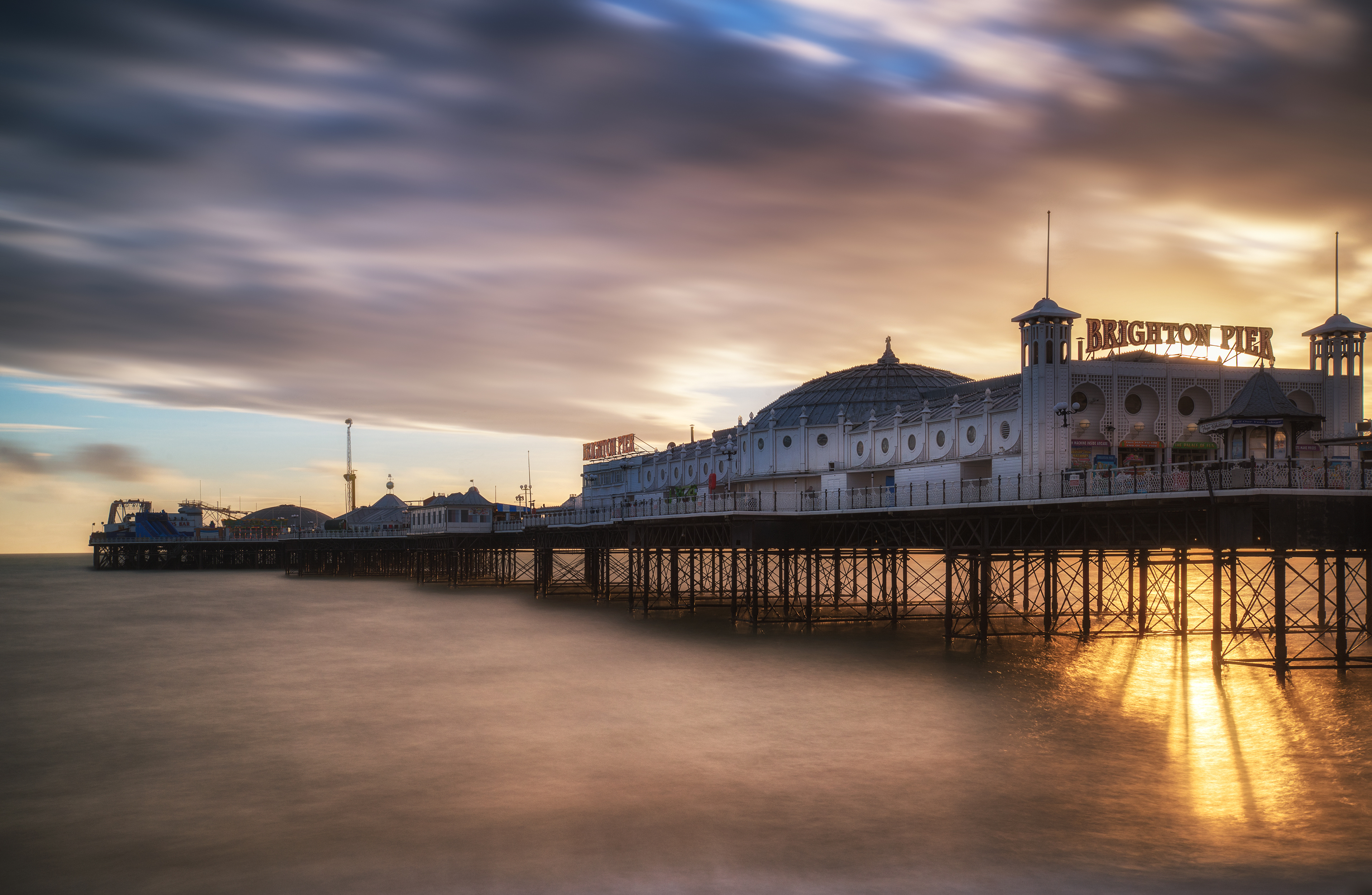Long exposure Winter sunset over Brighton Victorian pier.